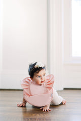 baby infant girl wearing light pink blush ruffle angel bib by bibtique