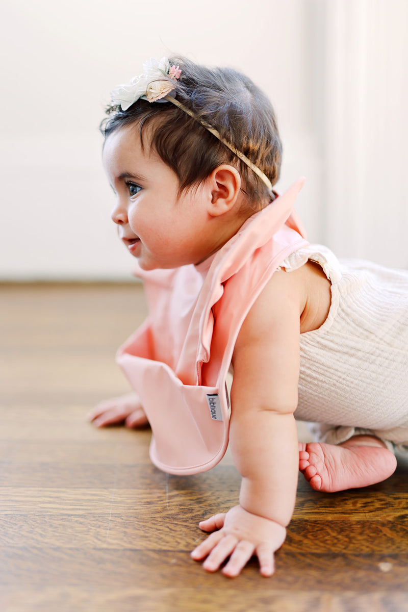 baby infant girl wearing light pink blushruffle angel bib by bibtique