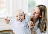 mom with baby girl wearing a Sky Blue ruffle Angel Bib